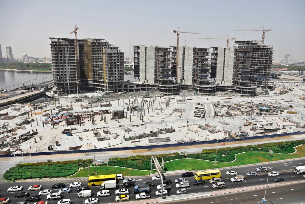 Tower blocks under construction beside a Dubai highway